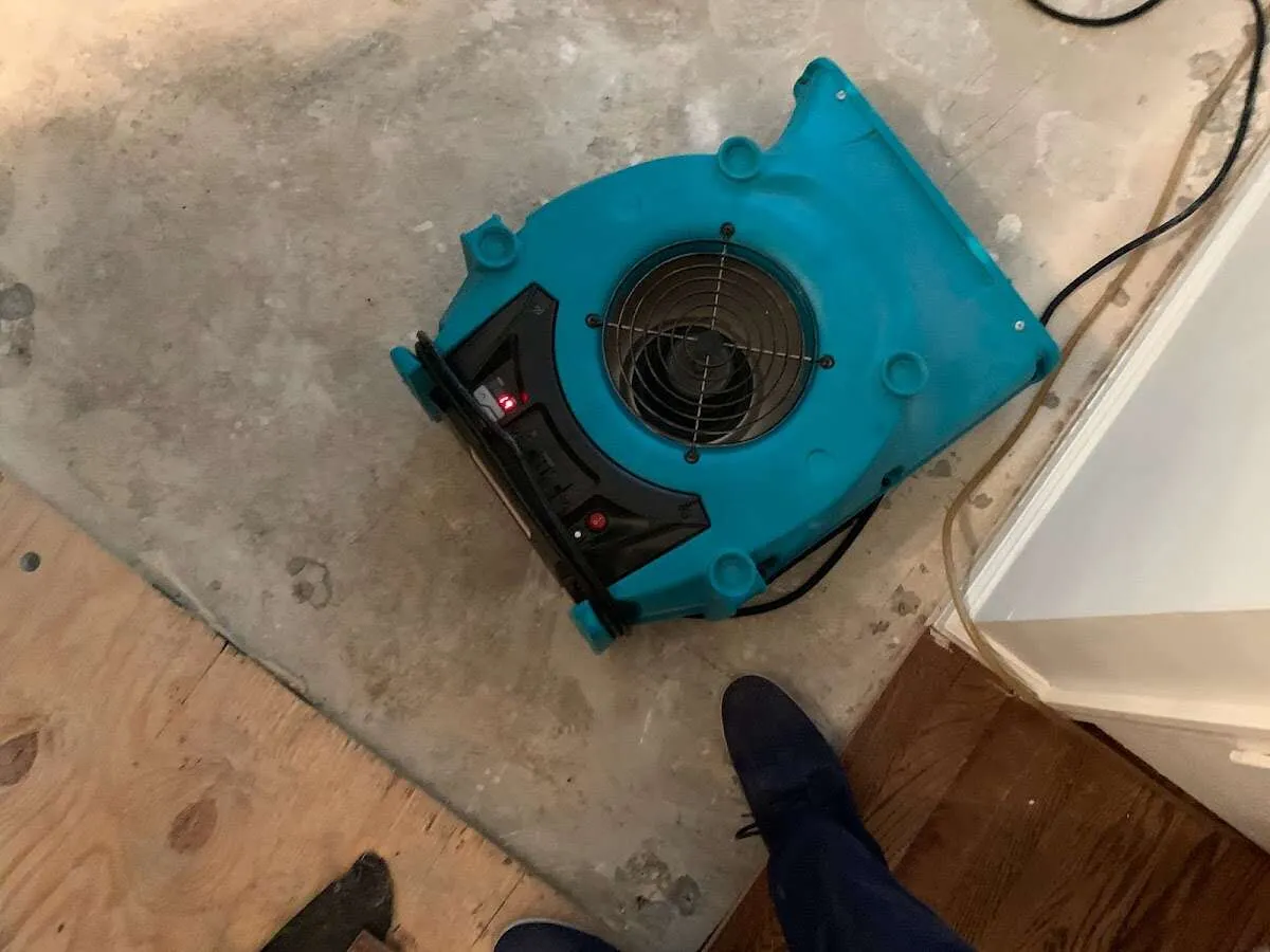 Air mover drying subfloor during Commercial Water Damage Restoration in Nephi